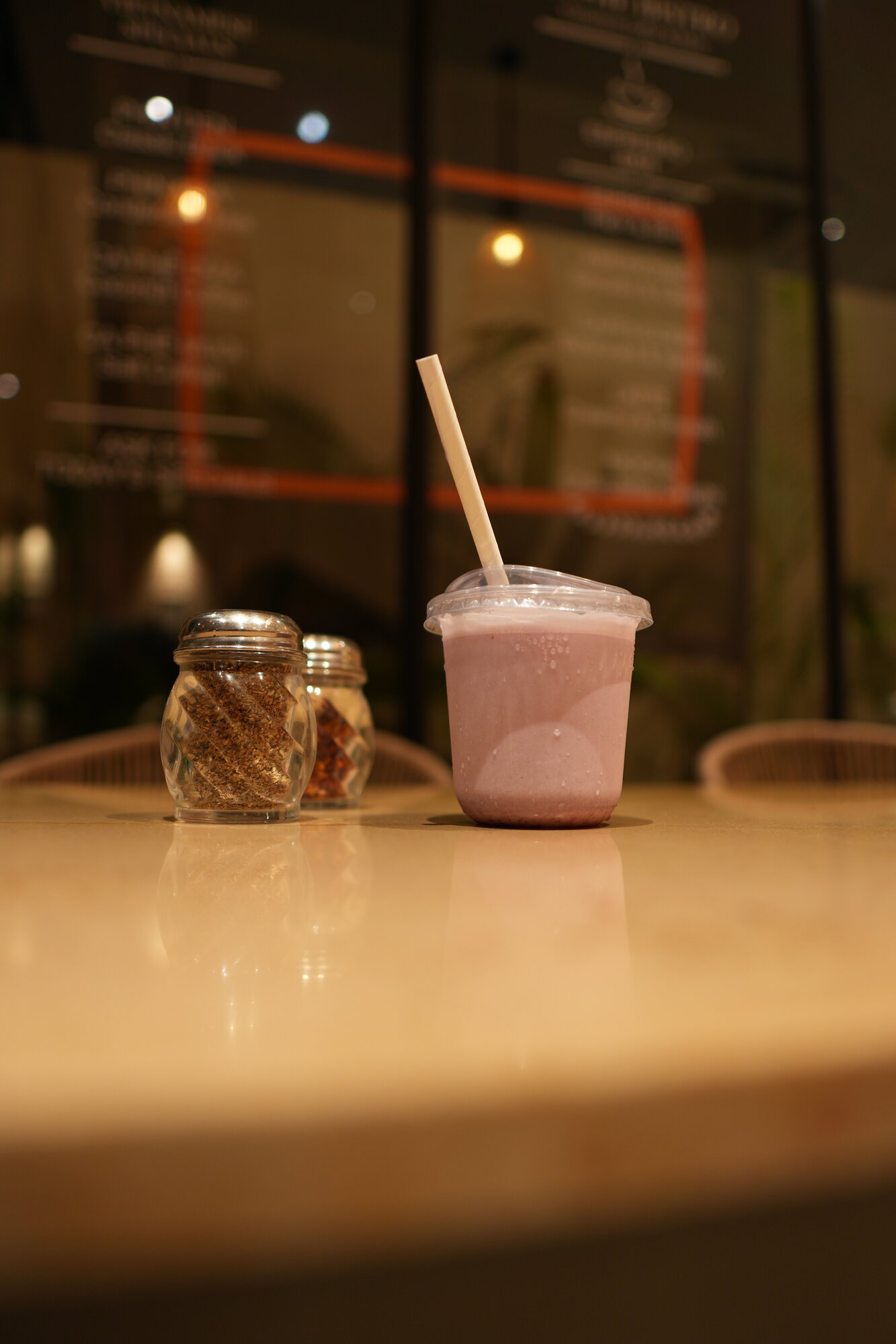 Smoothie on tabletop with spice jars