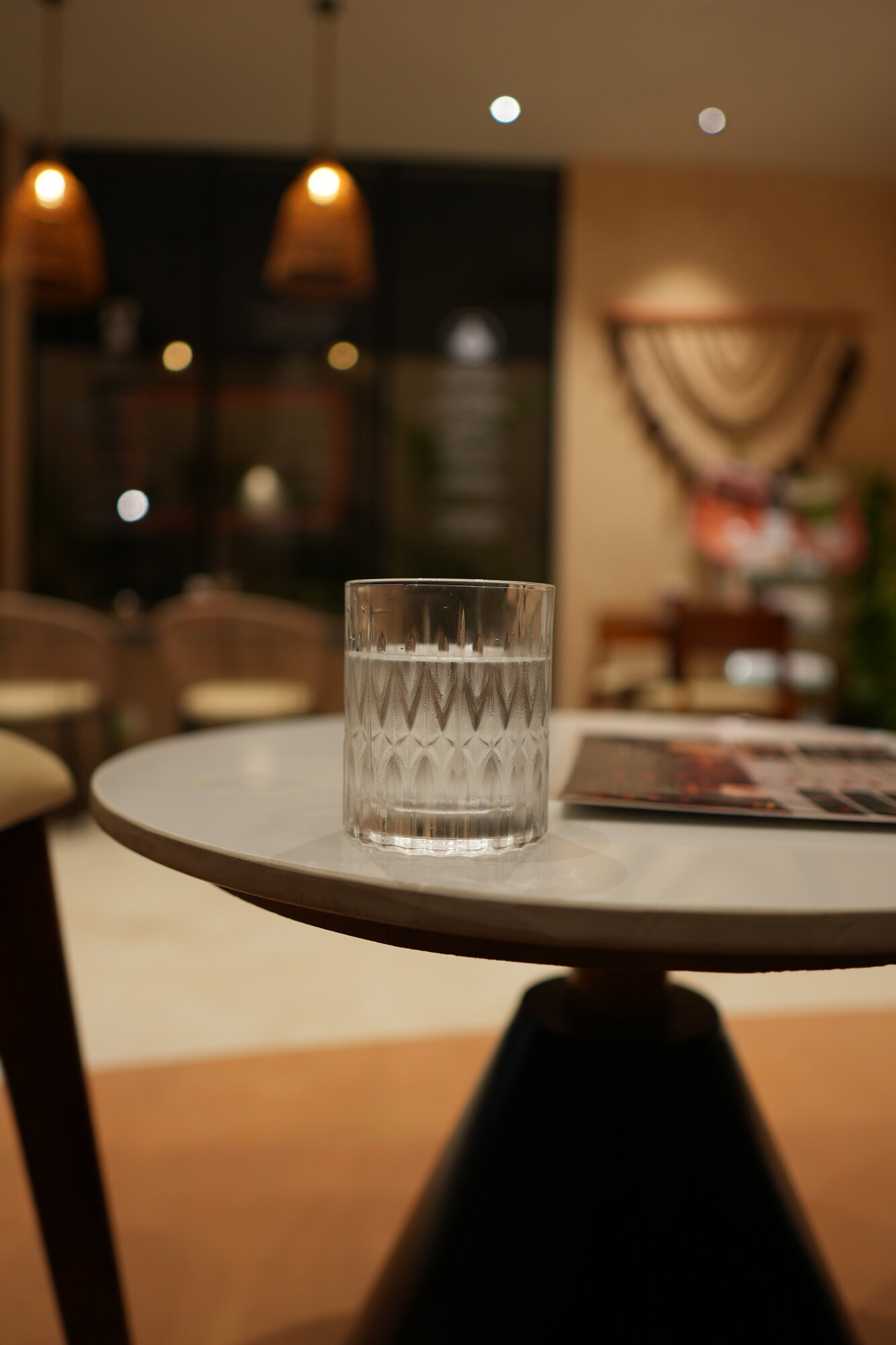 Cut-glass water tumbler on marble tabletop